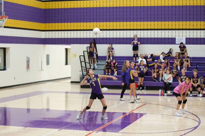 Fort Worth Teen playing volleyball at school.