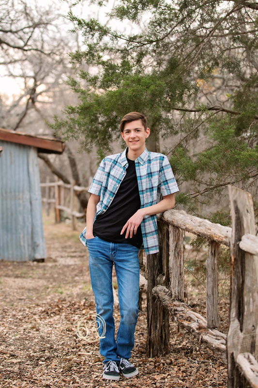 Senior photo shoot with teen guy at Eagle Mountain Park in Saginaw.