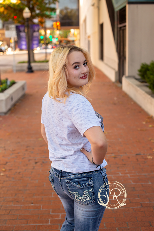 Gorgeous senior girl posing in front on a sidewalk in Fort Worth, Texas. 