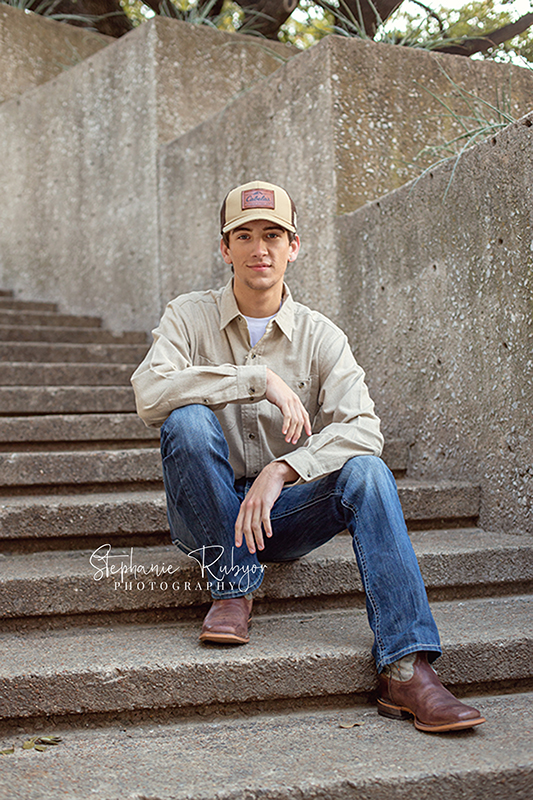 Senior guy sitting on a staircase posing for his photo shoot. 