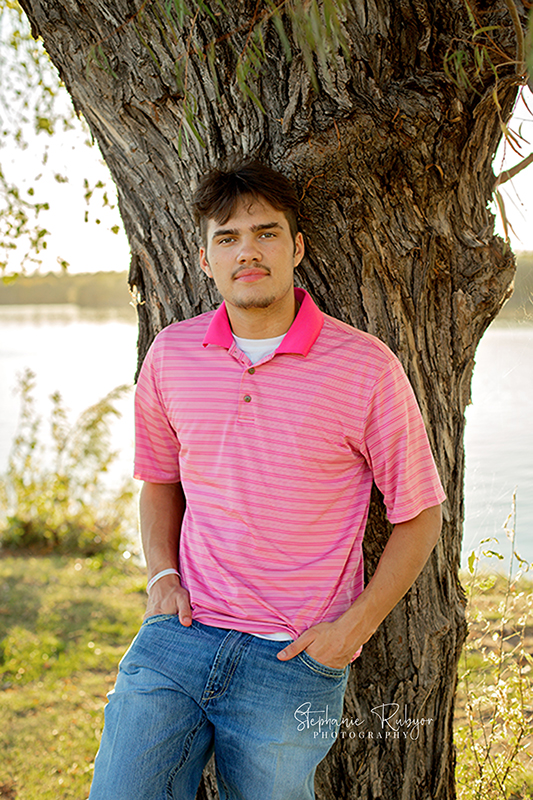 Weston casually poses for his senior pictures in Fort Worth park. 