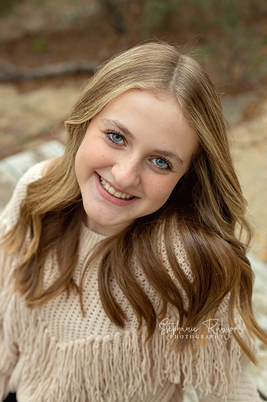 Beautiful senior Grace poses for a senior photo session at Eagle Mountain Park in Fort Worth. 