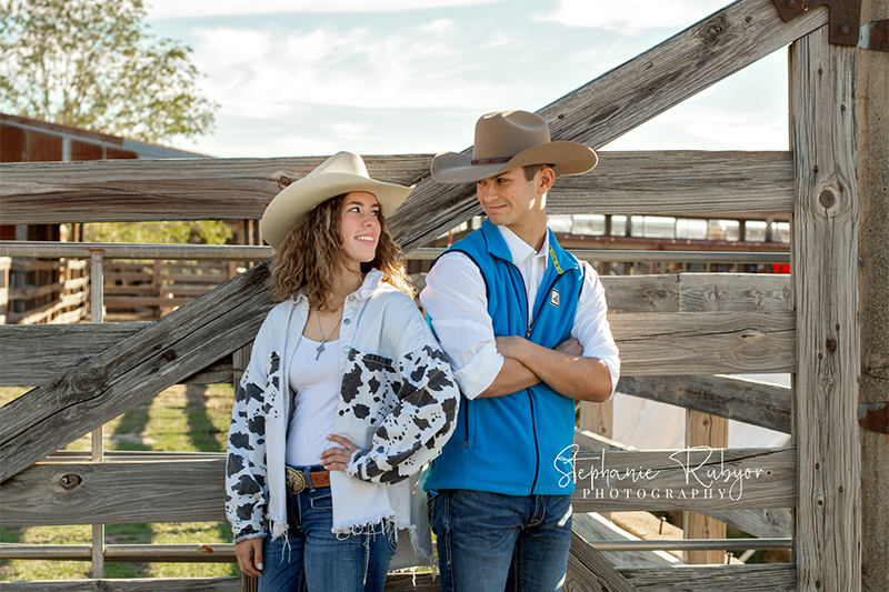 Luke and Ripley posing for their senior pictures by a fence in Fort Worth, TX.