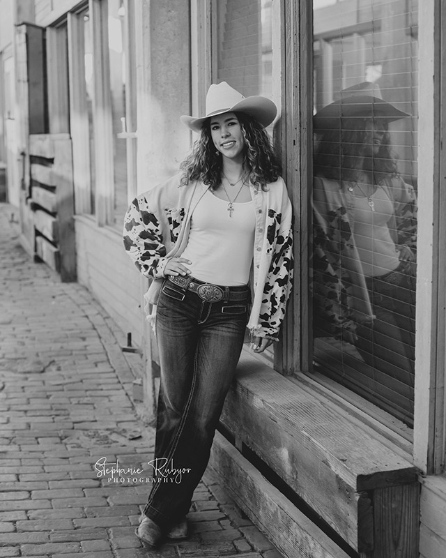Black and white image of a senior girl at the Stockyards in downtown Fort Worth, Texas. 