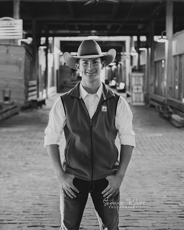 Black and white image of a senior boy at the Stockyards in downtown Fort Worth, Texas. 