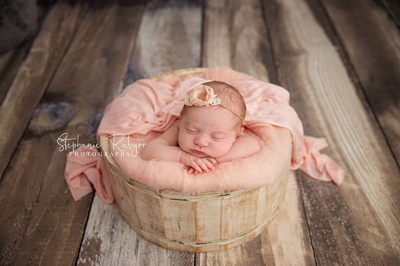 Fort Worth Texas newborn asleep in a cream bucket.
