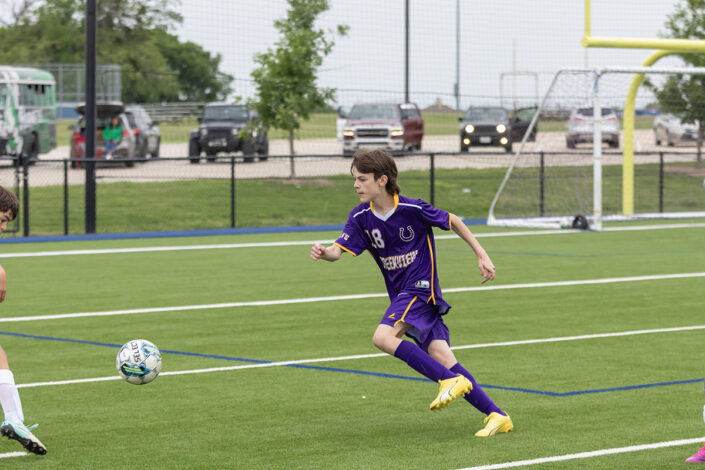 Soccer player at a Saginaw, Texas high school making a play on the ball.