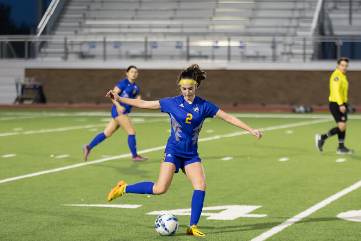 Soccer player at a Saginaw, Texas high school making a play on the ball.