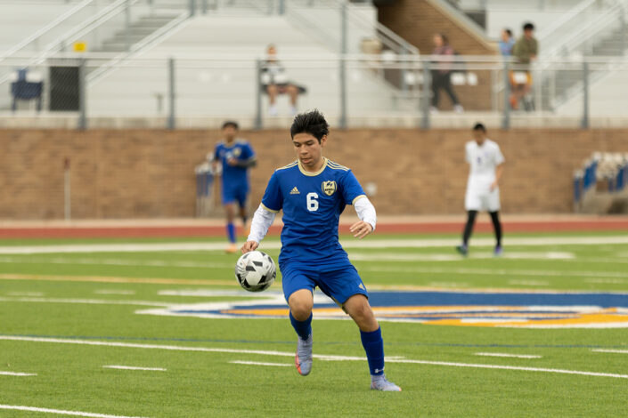 Soccer player at a Saginaw, Texas high school making a play on the ball.