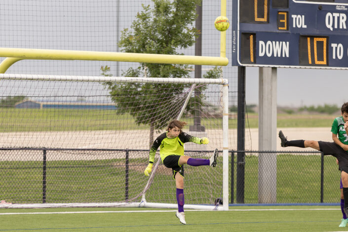 Soccer player at a Saginaw, Texas high school making a play on the ball.