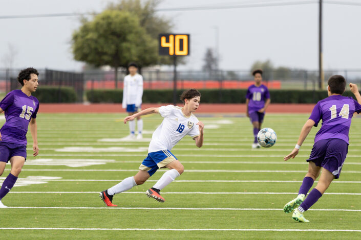 Soccer player at a Saginaw, Texas high school making a play on the ball.