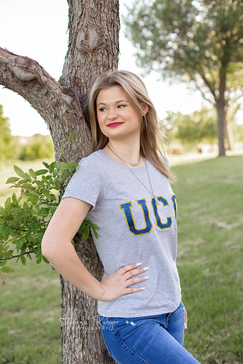 High school senior in a park in Fort Worth, Texas for a photo session celebrating her upcoming graduation. 