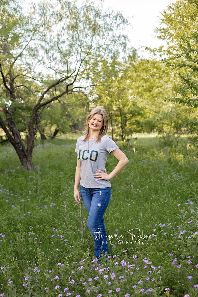 High school senior in a park in Fort Worth, Texas for a photo session celebrating her upcoming graduation. 