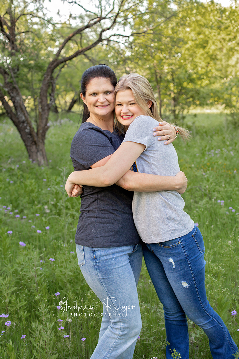 Senior girl and her mom hugging at a senior photo shoot in Saginaw, Texas.