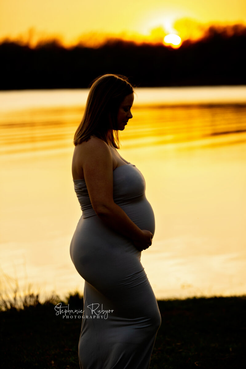 Pregnant mother to be at sunset by the lake in Saginaw maternity photo session.