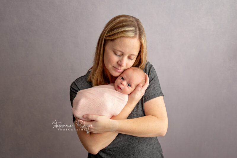 Mom holding her newborn daughter at Fort Worth photo session.