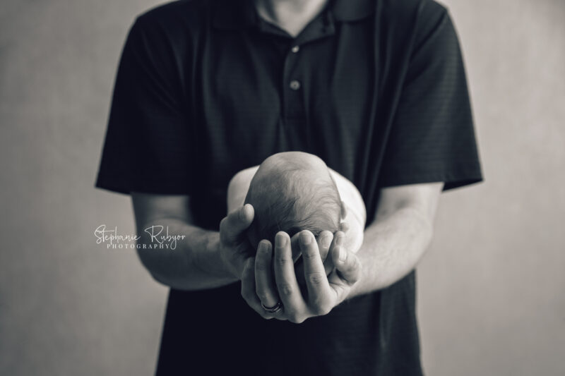 Dad holding his newborn daughter at Fort Worth photo session.