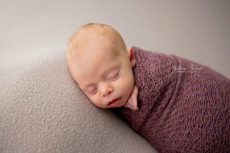 Newborn baby sleeping on blanket at a newborn photo session in Fort Worth, Texas.