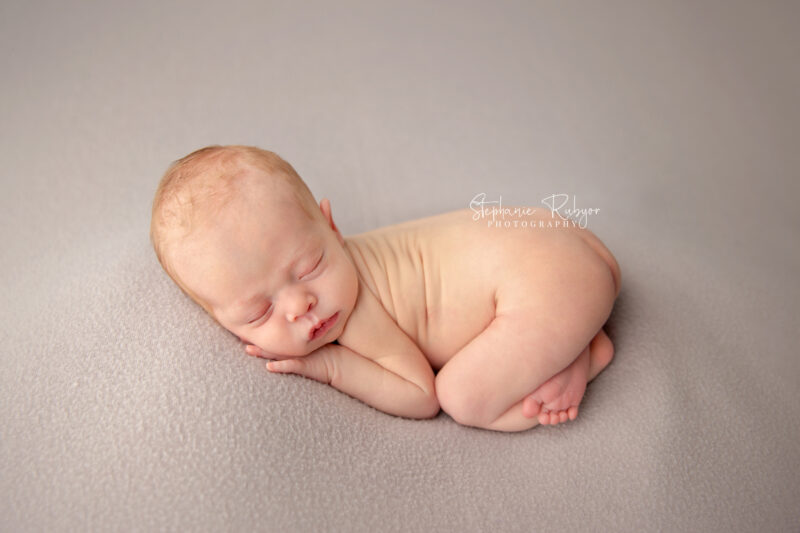 Newborn baby sleeping on blanket at a newborn photo session in Fort Worth, Texas.