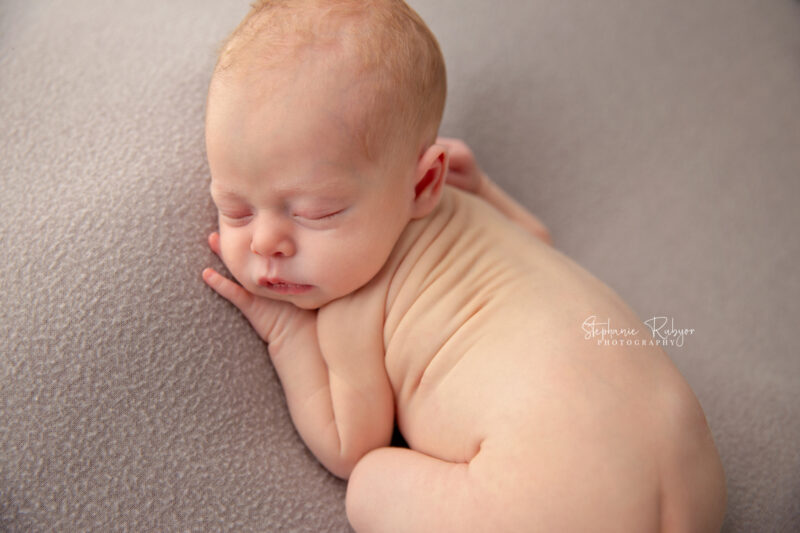 Newborn baby sleeping on blanket at a newborn photo session in Fort Worth, Texas.