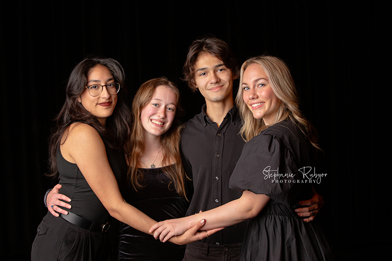 Theatre officers and high school seniors from Boswell High School in Fort Worth posing for a photo session on stage.