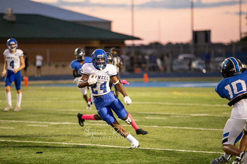 High school football player in Fort Worth, Texas playing a football game.