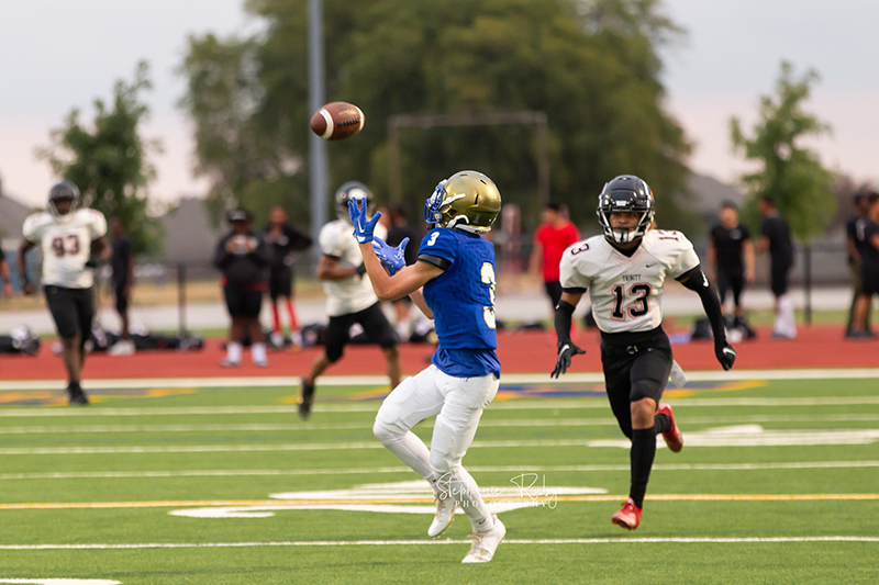 High school football player in Fort Worth, Texas playing a football game.