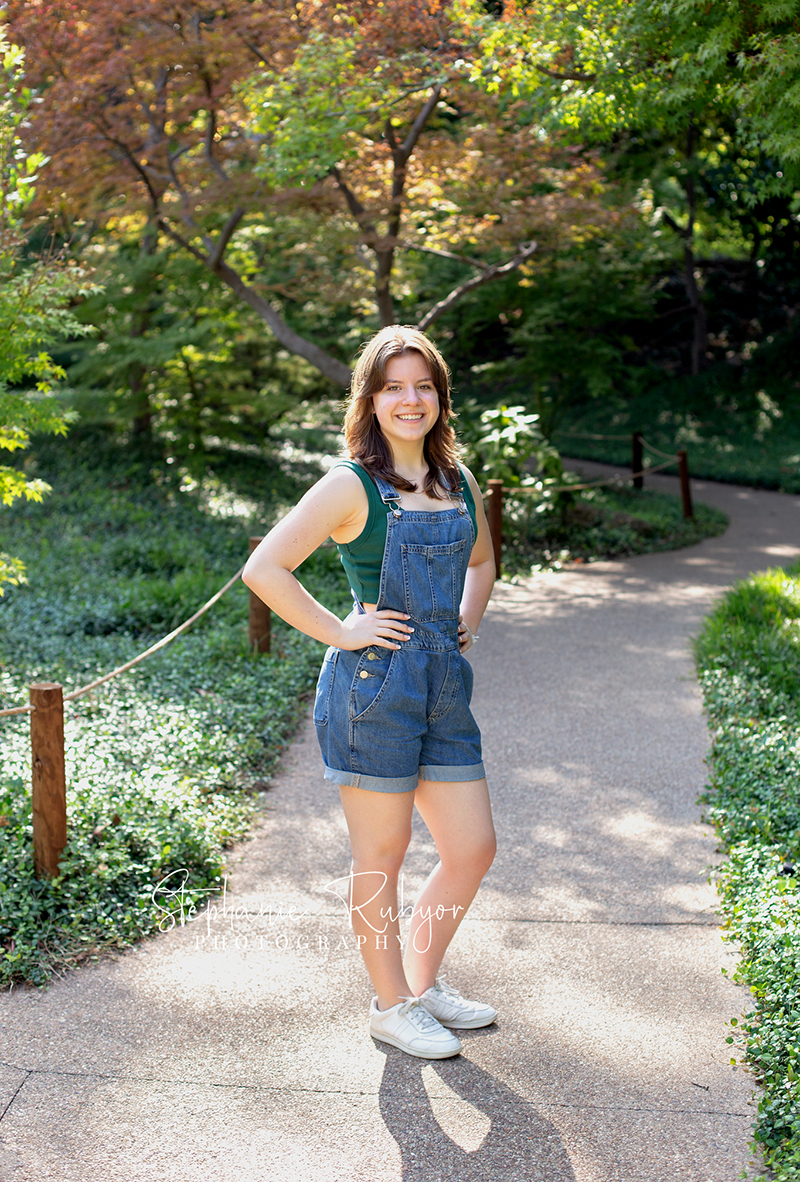 Reilly is posing for her senior session at the Fort Worth Botanic Gardens in the summer before her senior year.