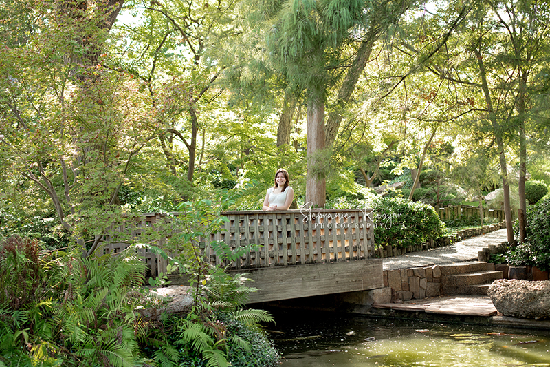 Reilly is posing for her senior session at the Fort Worth Botanic Gardens in the summer before her senior year.