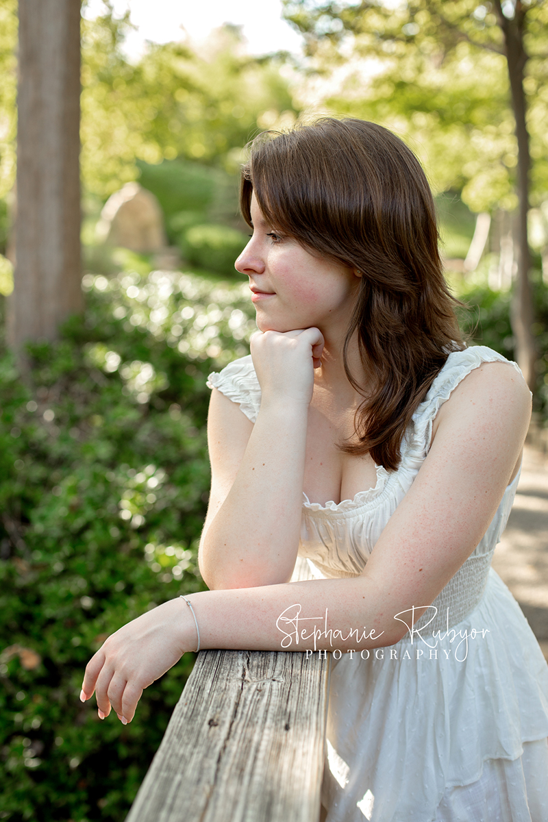 Reilly is posing for her senior session at the Fort Worth Botanic Gardens in the summer before her senior year.