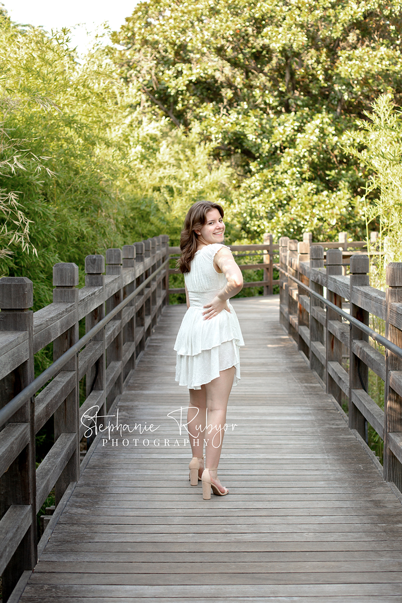 Reilly is posing for her senior session at the Fort Worth Botanic Gardens in the summer before her senior year.