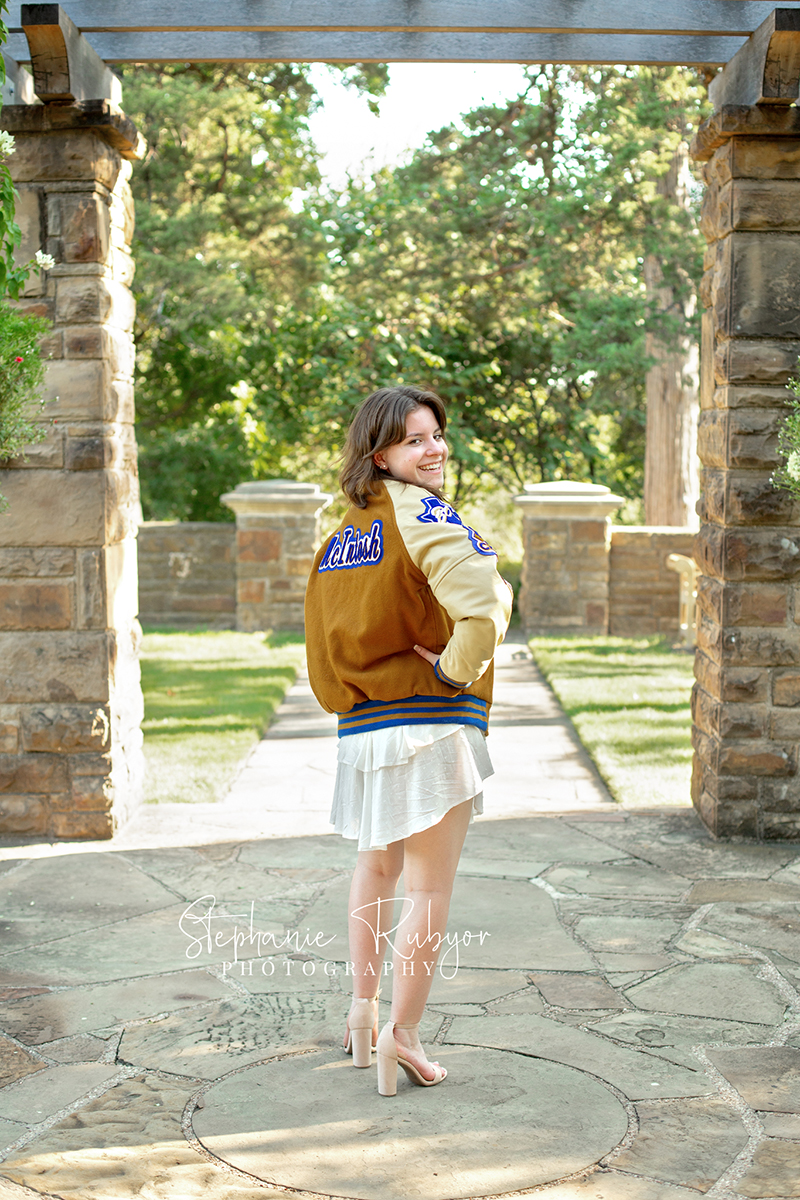 Reilly is posing for her senior session at the Fort Worth Botanic Gardens in the summer before her senior year.