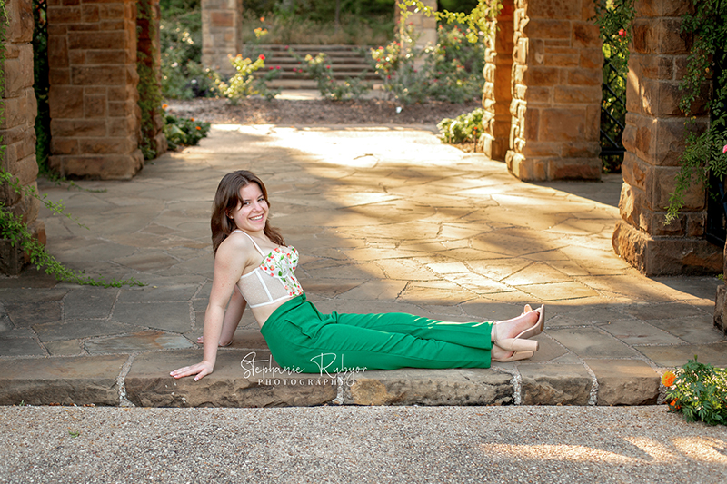 Reilly is posing for her senior session at the Fort Worth Botanic Gardens in the summer before her senior year.