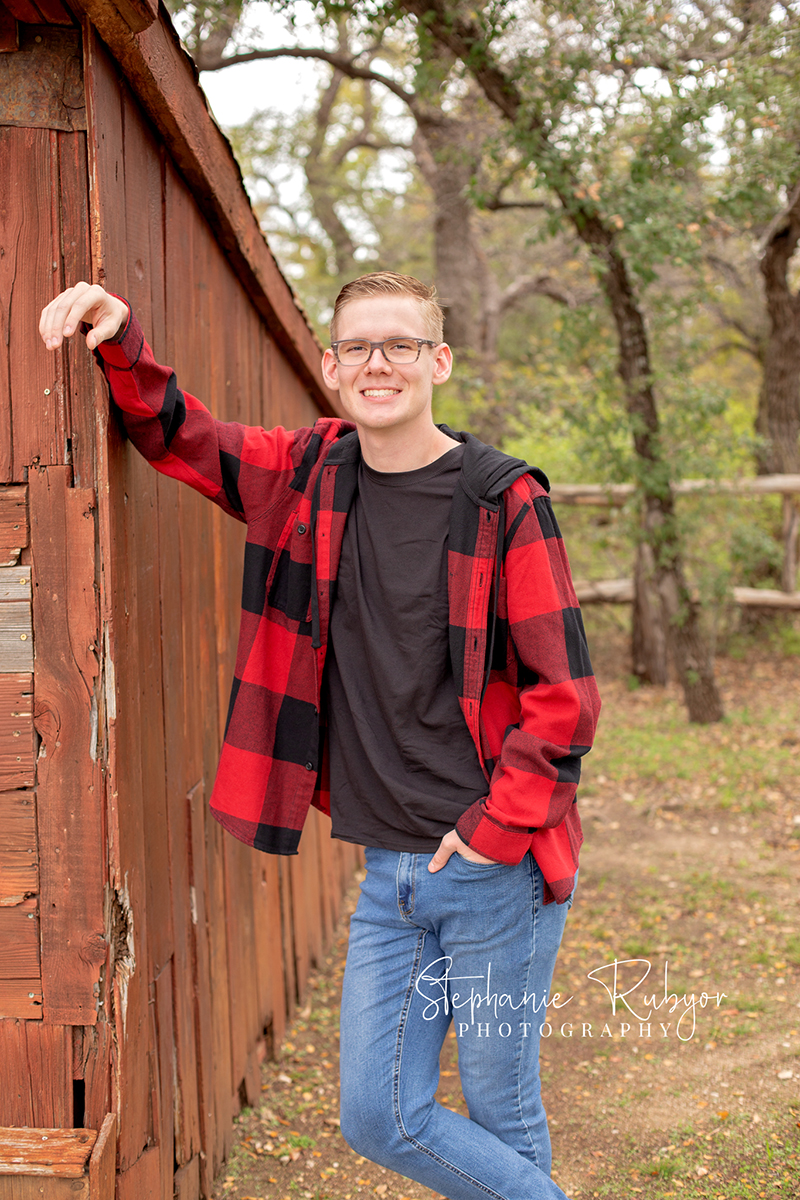 Senior guy from Las Vegas who came to Fort Worth posing for his senior pictures at Eagle Mountain Lake Park in Fort Worth, Texas. 