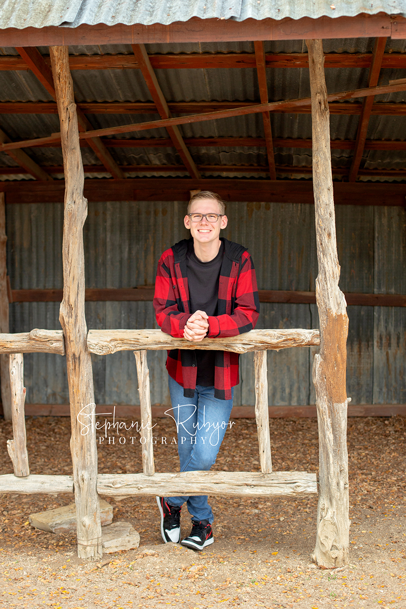 Senior guy from Las Vegas who came to Fort Worth posing for his senior pictures at Eagle Mountain Lake Park in Fort Worth, Texas. 