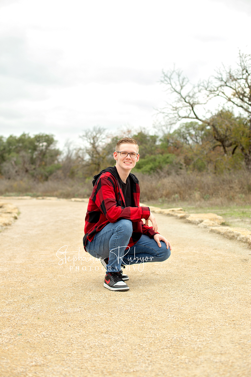 Senior guy from Las Vegas who came to Fort Worth posing for his senior pictures at Eagle Mountain Lake Park in Fort Worth, Texas. 