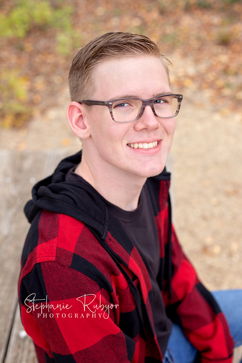 Senior guy from Las Vegas who came to Fort Worth posing for his senior pictures at Eagle Mountain Lake Park in Fort Worth, Texas. 