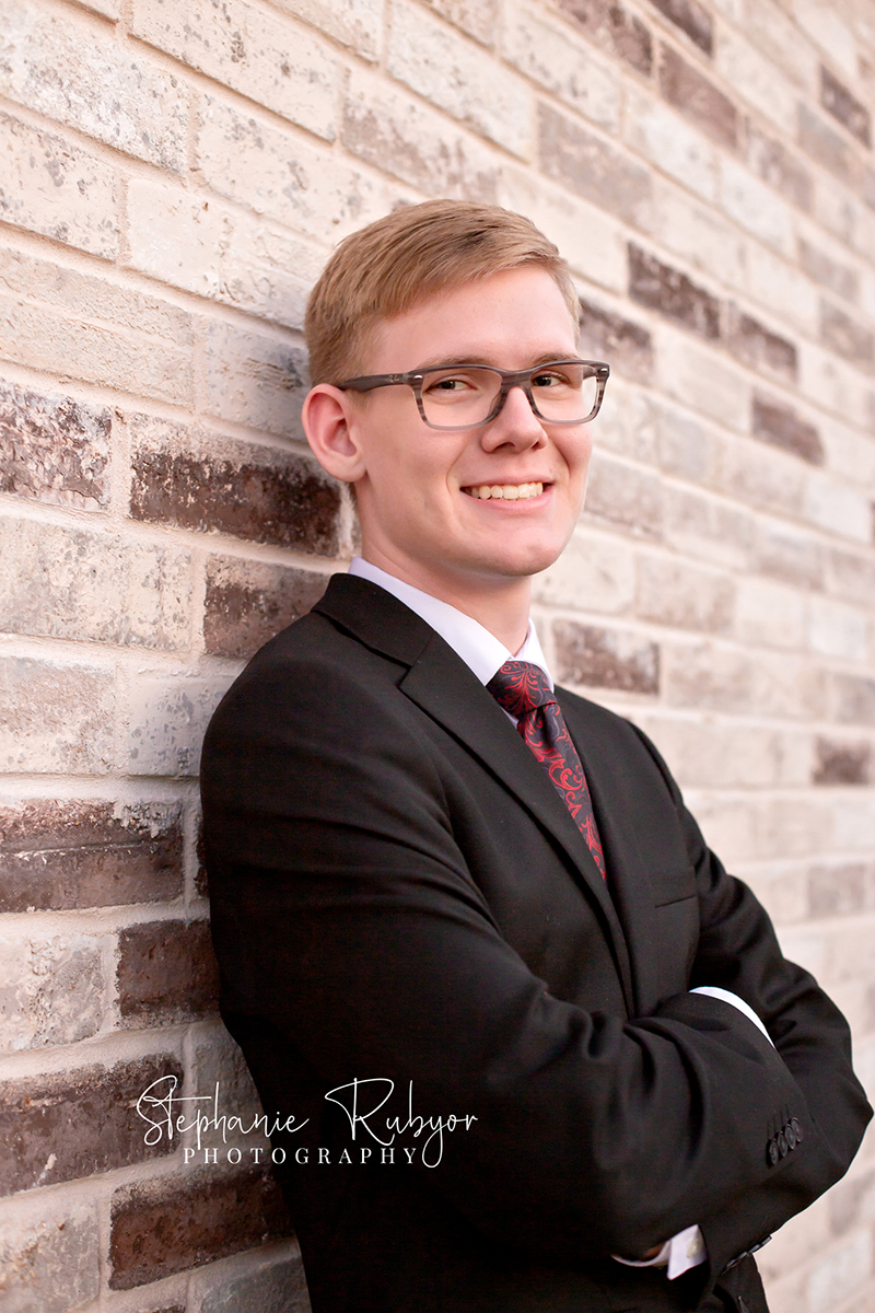 Senior guy from Las Vegas who came to Fort Worth posing for his senior pictures in downtown Fort Worth. 