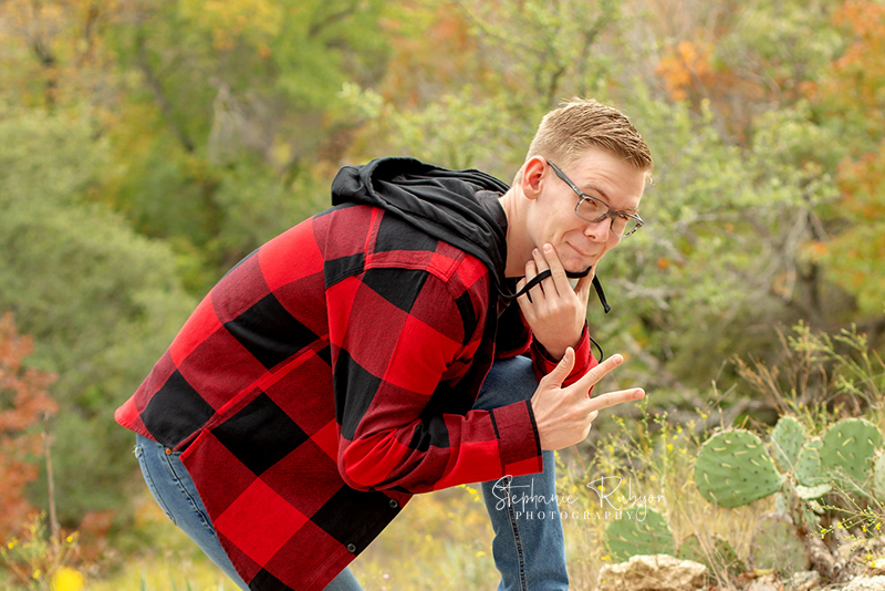 Senior guy from Las Vegas who came to Fort Worth posing for his senior pictures at Eagle Mountain Lake Park in Fort Worth, Texas.
