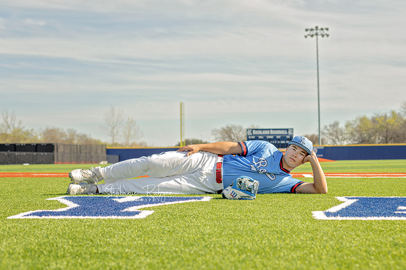 High school senior boy does some baseball sports portraits for his senior photo session in Richland Hills, Texas. 