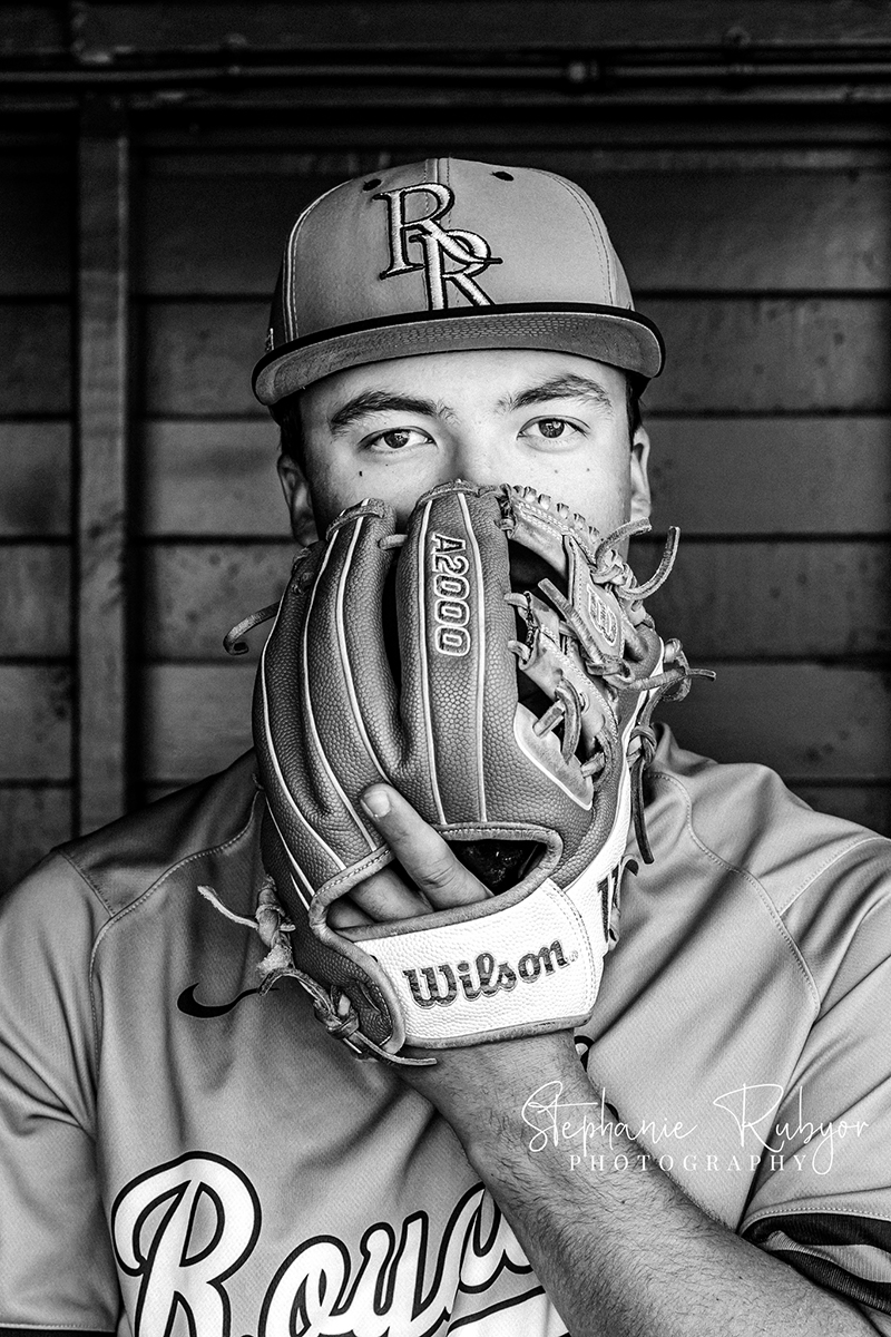 High school senior boy does some baseball sports portraits for his senior photo session in Richland Hills, Texas. 