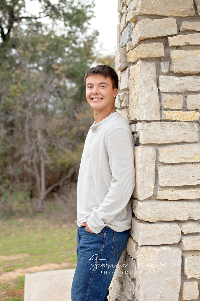 Richland Hills senior boy poses for pictures at a photo session at Eagle Mountain Park. 