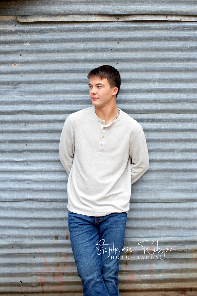 Richland Hills senior boy poses for pictures at a photo session at Eagle Mountain Park. 