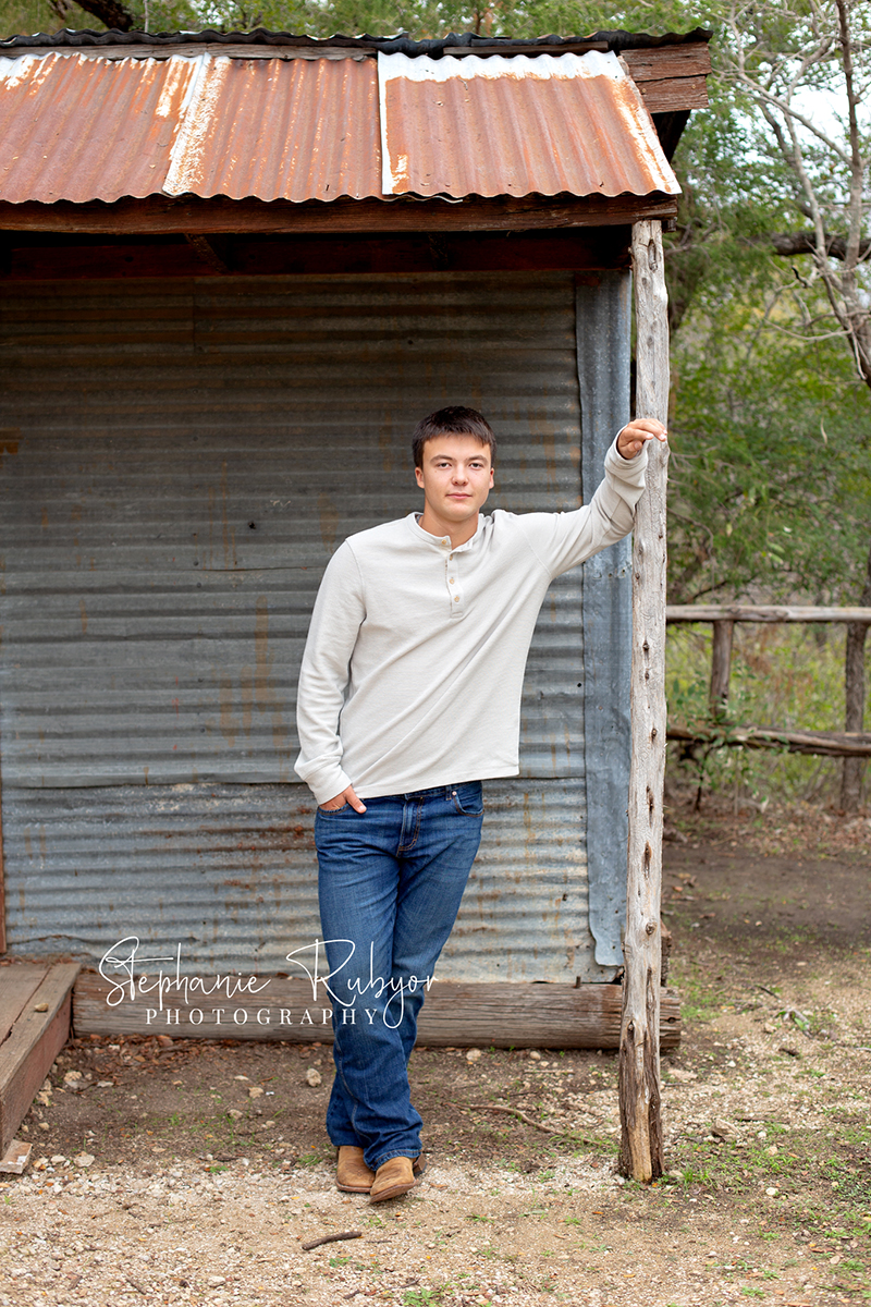 Richland Hills senior boy poses for pictures at a photo session at Eagle Mountain Park. 