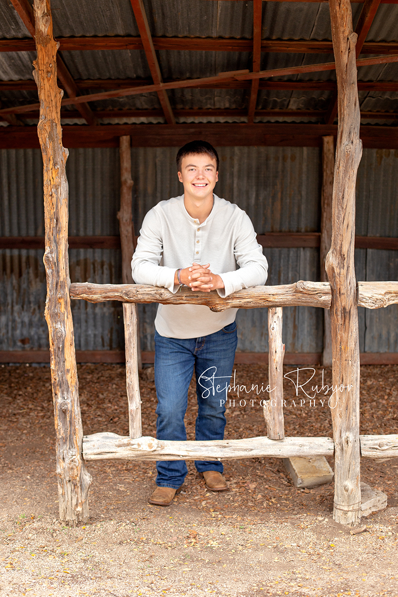 Richland Hills senior boy poses for pictures at a photo session at Eagle Mountain Park.