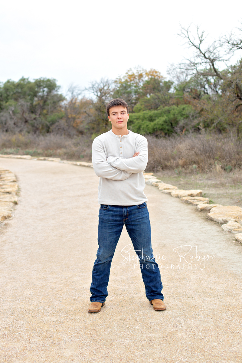 Richland Hills senior boy poses for pictures at a photo session at Eagle Mountain Park. 