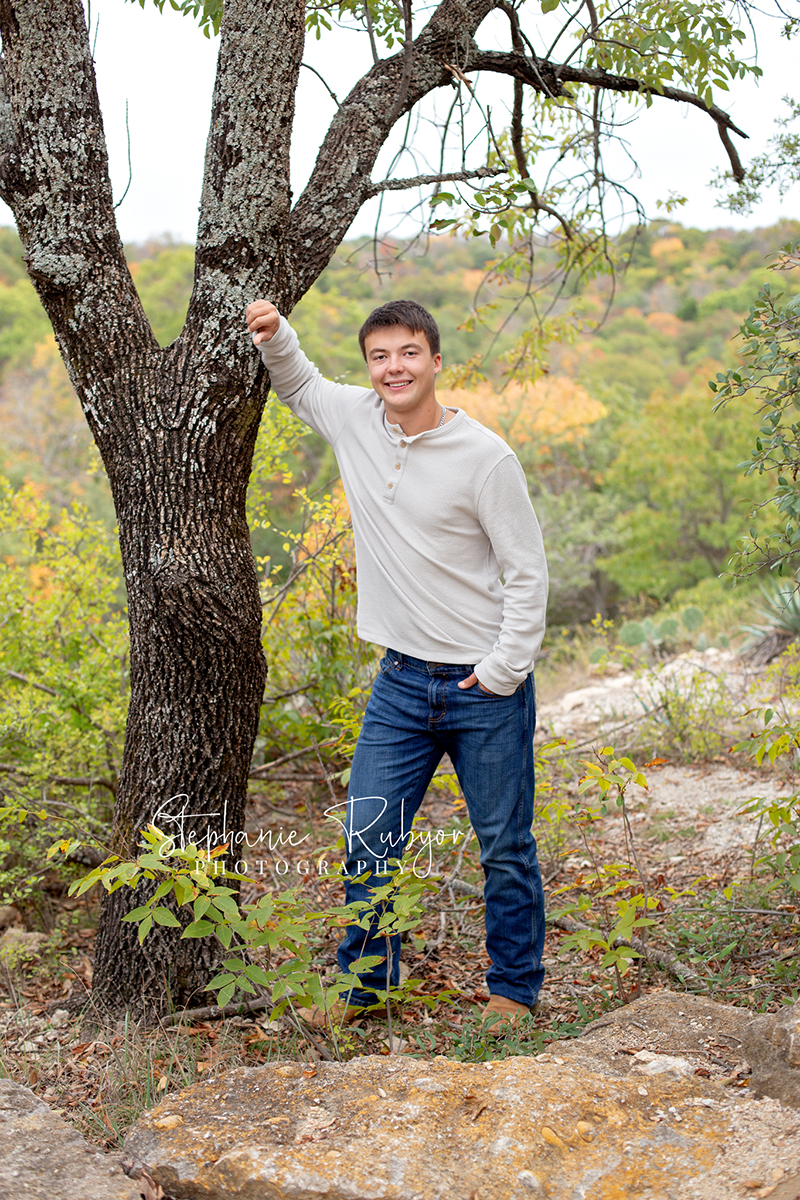 Richland Hills senior boy poses for pictures at a photo session at Eagle Mountain Park. 