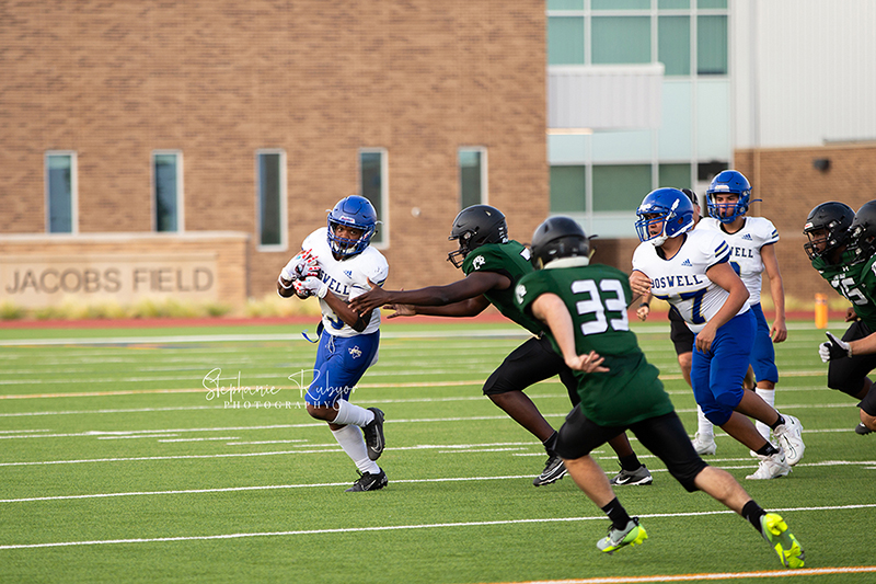 High school football player in Fort Worth, Texas playing a football game. 