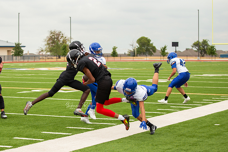 High school football player in Fort Worth, Texas playing a football game. 