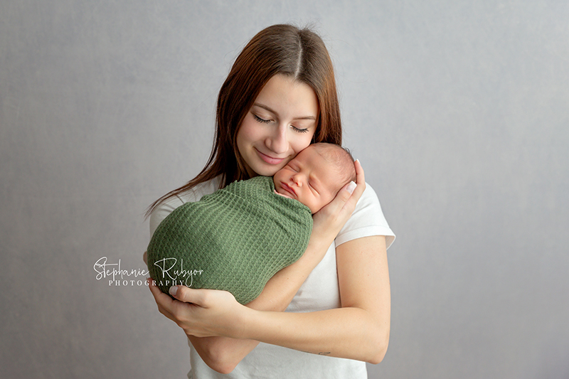 Baby boy posing with mom at Fort Worth newborn session. 